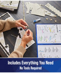 Hands assembling Millennium Falcon 3D Model Kit For Star Wars Fans And Collectors with instructions and parts visible