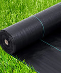 Heavy Duty 6 By 300 Ft Weed Barrier Landscape Fabric roll on grass, 3.2 oz material for effective weed blocking.
