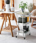 3 Tier Rolling Utility Cart With Drawer And Wood Tabletop Maple Finish in home office setting with books and plant on top