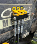 Close-up of installed yellow grease fitting caps on machinery showing the integrated collar; Grease Fitting Caps 50 Count Yellow Must Have For Any Mechanic Fits All Standard SAE And Metric Fittings With Integrated Collar That Keeps Cap Attached For Quick Maintenance And Keeps Dirt Out And Prolongs Fitting Life.