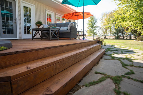 Heavy Duty Wood Stain And Sealer In One For Decks, 5 Gallon Semi Transparent Waterproof Coating In Light Walnut on wooden steps.