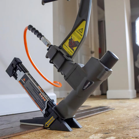 Three In One Pneumatic Flooring Nailer And Stapler For Tongue And Groove Hardwood with mallet and interchangeable base plates in use