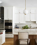 Modern kitchen with Antique Copper Single Hole Cabinet Handles Set on white cabinets and island, soft gloss finish