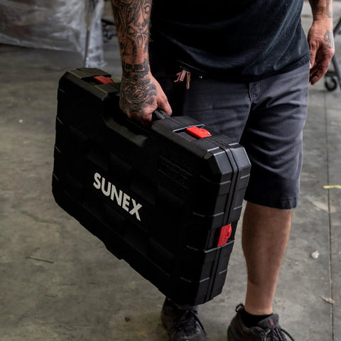 Person carrying 80 Piece 3/8 Inch Drive Master Impact Socket Set With Universal, Star And External Star Sockets in black case
