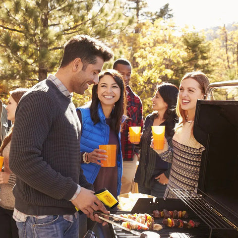 Person using Beast Dual Laser Non-Contact Infrared Thermometer for Surface Temperature during a BBQ gathering with friends