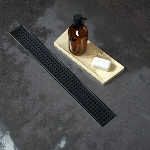24 Inch Linear Shower Drain With Removable Square Pattern Grate Matte Black Stainless Steel Includes Hair Strainer next to soap tray