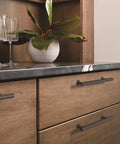 Matte Black Radius Cabinet Pull For Cabinets And Drawers In Contemporary Modern Style installed on wooden kitchen drawers.