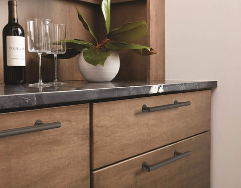 Matte Black Radius Cabinet Pull For Cabinets And Drawers In Contemporary Modern Style installed on wooden kitchen drawers.