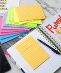 Huge 4x6 Lined Sticky Notes 12 Pack With 30 Sheets Per Pad, Ultra Sticky Notes In Bright Colors next to an open planner on desk.