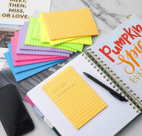 Huge 4x6 Lined Sticky Notes 12 Pack With 30 Sheets Per Pad, Ultra Sticky Notes In Bright Colors next to an open planner on desk.