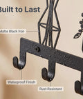 Close-up of Knockout Premium Decorative Floral Metal Wall Coat Rack featuring six heavy duty hooks and matte black finish.