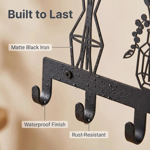 Close-up of Knockout Premium Decorative Floral Metal Wall Coat Rack featuring six heavy duty hooks and matte black finish.
