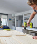 High Output 18V Cordless Drill Driver With 22 Torque Settings And Self Tightening Chuck, Includes 2.0Ah And 4.0Ah Lithium Batteries in use on wooden door.