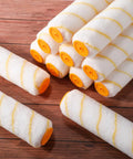 Top Tier 48 Pieces 18 Inches Paint Roller Covers Crafted With Plush Microfiber For A No Sweat Home Wall Project Heavy Duty Fast Drying Yellow 3 8 Nap Roll Cover Kit laying on a wooden surface.