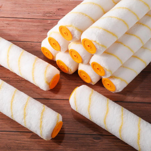 Top Tier 48 Pieces 18 Inches Paint Roller Covers Crafted With Plush Microfiber For A No Sweat Home Wall Project Heavy Duty Fast Drying Yellow 3 8 Nap Roll Cover Kit laying on a wooden surface.
