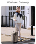Woman walking with underseat carry on luggage with wheels lightweight soft travel bag with PVC wet dry pockets personal item suitcase
