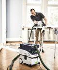 Person using CT MIDI I Dust Extractor With HEPA Filter, Bluetooth Start, AutoClean System, Heavy Duty Suction Power, and Touch Controls on flooring