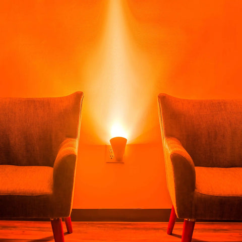 Plug In Wall Sconce Uplighter With GU10 Spotlight Wash Light illuminating wall between two chairs with cozy ambient glow