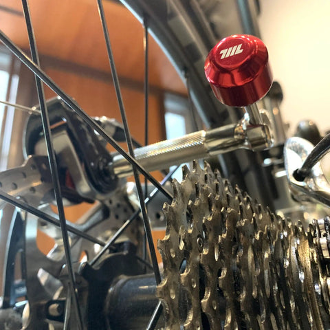 Lollipop Bit Driver Stainless Steel Red With Hidden Shaft For Quick Bit Changes And Maximum Torque shown attached to bike