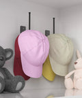Heavy Duty Stainless Steel Hat Organizer And Hat Rack For Wall with pink, red, yellow caps on display next to plush toys.