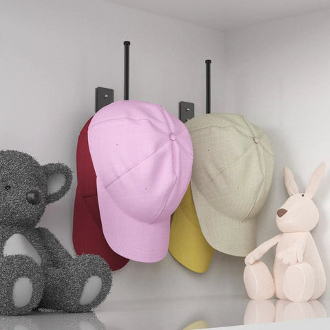 Heavy Duty Stainless Steel Hat Organizer And Hat Rack For Wall with pink, red, yellow caps on display next to plush toys.