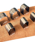 Leather Corner Punch Set With 18 Pieces In 6 Sizes And 3 Shapes shown on mat, various steel cutters for leather crafting