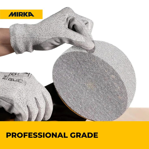 Gloved hand holding Six Inch Dust Free Sanding Discs With Hook And Loop Mesh For Orbital Sanders Pro Grade Dust Extraction.