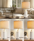 White Ceramic Table Lamps Set Of 2 With USB Charging Ports For A Cozy Modern Nightstand Vibe 28 Inch Tall Linen Drum Shade 3 Way Dimmable Touch Includes 2 LED Bulbs For Living Room And Bedroom showing dimmable settings in a living room.