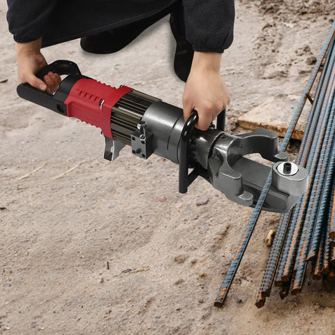 person using 1150W Hydraulic Electric Rebar Bender to bend 4-25mm steel rods on construction site, showing precise handling.