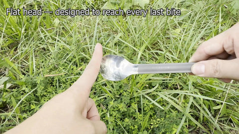 Ultralight Titanium Long-Handle Spoon With Polished Bowl For Trail-Ready Hiking held in hand against grass background