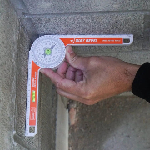 Hand using Badass 3-Way Bevel Angle Finder And Miter Protractor With Integrated Spirit Level for precise angle measurement