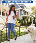 26 Pack Decorative Garden Fence 22 Inch By 28 Foot Arched No Dig Border Fence installed in front of a house with dog and person walking