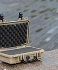 Open rugged portable all weather waterproof hard case with customizable foam for drones cameras and gear the dry case you can trust IP67 rated protection for travel storage and outdoor adventures shown on wet surface