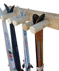 Built Tough Game Changing Heavy Duty Solid Wood Log Style Wall Mount Ski Rack Holds Six Pairs Of Skis And Poles Indoor Garage Wall Space Saver Organizer Rack Natural Finish with skis organized on holders.