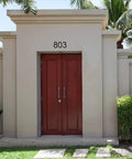 Entrance with a modern 8 Inch Floating House Number 1 Easy To Read From Street Modern Metal Mount above red double doors.