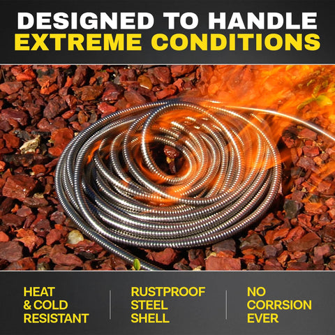 Coiled metal garden hose extension, ribbed stainless-steel, 10 ft length on red mulch.