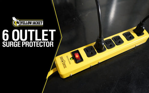 Beefy Metal Surge Protector Strip With Six Outlets And 15 Foot Yellow Cord on black surface