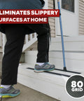 A person walking on white stairs with Anti Slip Stair Tape For Steps Black 4 Inch 60 Foot Durable Self Adhesive Non Slip Grip Tape.