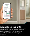 Hand holding smartphone displaying air quality report app interface with subscription note, in home setting.