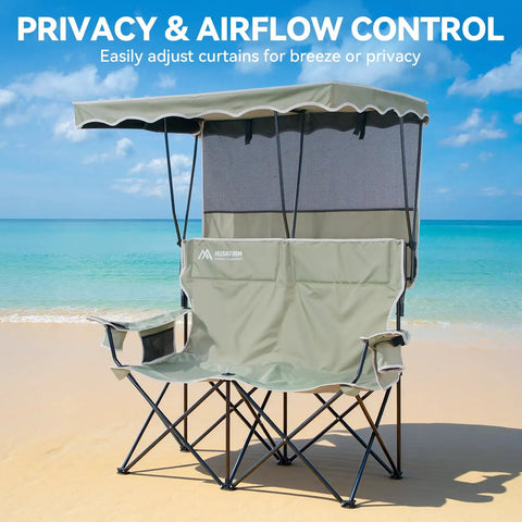 Double Camping Chair With Shade Canopy For Two People Folding Beach Chair on sandy beach with ocean backdrop