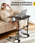 Adjustable Sit Stand Rolling Desk Built Tough With Slick Gliding Wheels And Multi Level Height Tuning For A Smooth Flex Workspace Anywhere Perfect For Daily Tasks And Keeping Your Posture On Point While Working Remotely. Mobile desk with a wood top, supporting 50 lbs, used by a person on a couch.