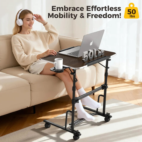 Adjustable Sit Stand Rolling Desk Built Tough With Slick Gliding Wheels And Multi Level Height Tuning For A Smooth Flex Workspace Anywhere Perfect For Daily Tasks And Keeping Your Posture On Point While Working Remotely. Mobile desk with a wood top, supporting 50 lbs, used by a person on a couch.