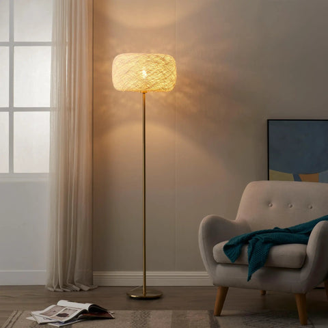 Rowan Brass Floor Lamp With Unique Thread Shade, Free Standing LED Light for modern living room decor beside gray armchair.
