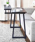 36 Inch Metal Table Bar Legs Heavy Duty Beefy Industrial Style With Adjustable Feet Pads Trapezoid Design supporting a desk in living room