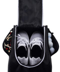Black Golf Shoe Bag with zippered carrier, holding white golf shoes, tees, and balls, featuring external pocket for easy trunk storage.