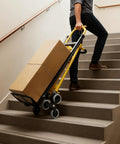 Hella Tough Aluminum Hand Truck And 3 In 1 Convertible Folding Dolly Cart With Stair Climbing Wheels moving boxes up stairs.