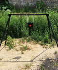 Outdoor setup of AR500 Steel Target Bullseye Gong 10 Inch Diameter 3/8 Inch Thick With Self Resetting Center Tone Spring For Pistol And Rifle Practice Pro Grade Steel Target Training.