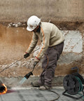 Worker using heavy duty extension cord reel with metal stand holds 500 feet of 6mm cable or hose open roller design