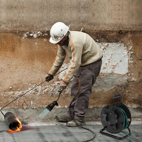 Worker using heavy duty extension cord reel with metal stand holds 500 feet of 6mm cable or hose open roller design