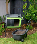48 Gallon Compost Tumbler With Cart Dual Compartment Geared System For Easy Emptying Elevated Base With Turning Lock Ratchet placed in garden
